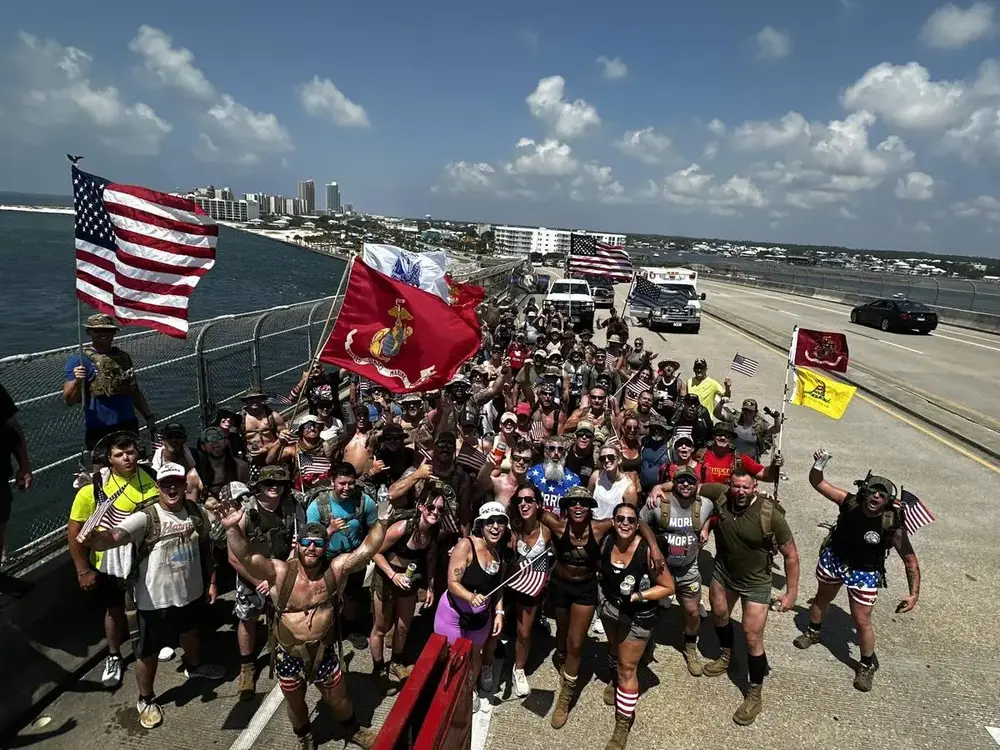 Large group of veterans marching with American flags at AV Active event